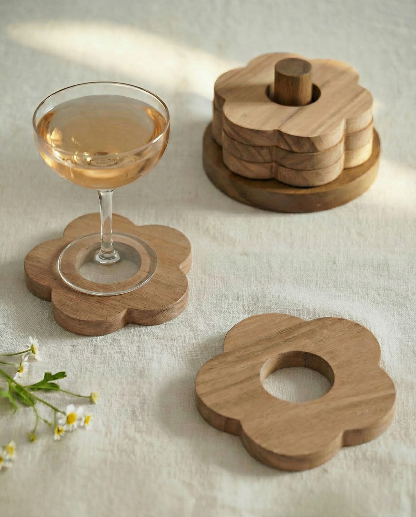 Flower-shaped wooden coasters beside a cold drink