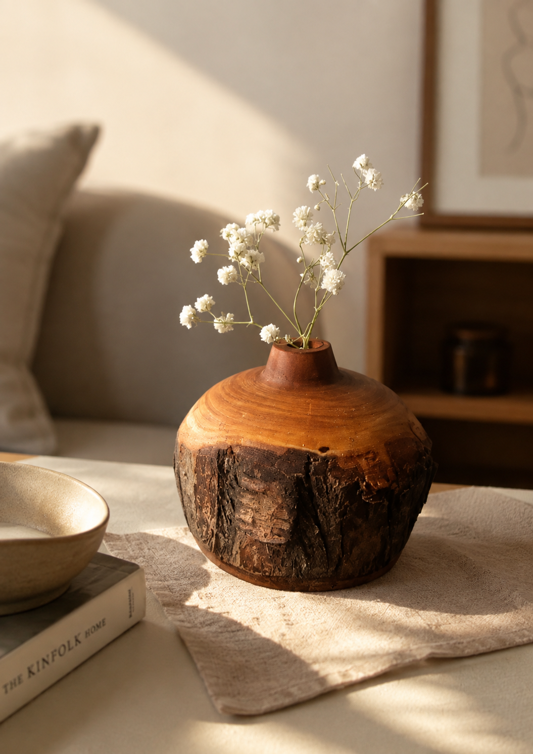 Sculpted live-edge wooden vase with dried flowers
