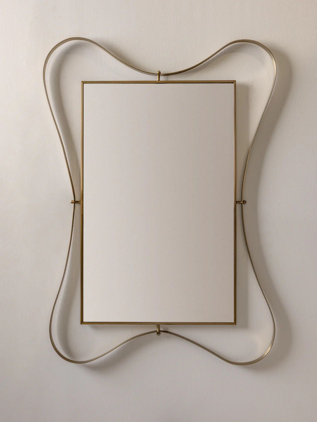 Rectangular mirror with curved brass ribbon frame