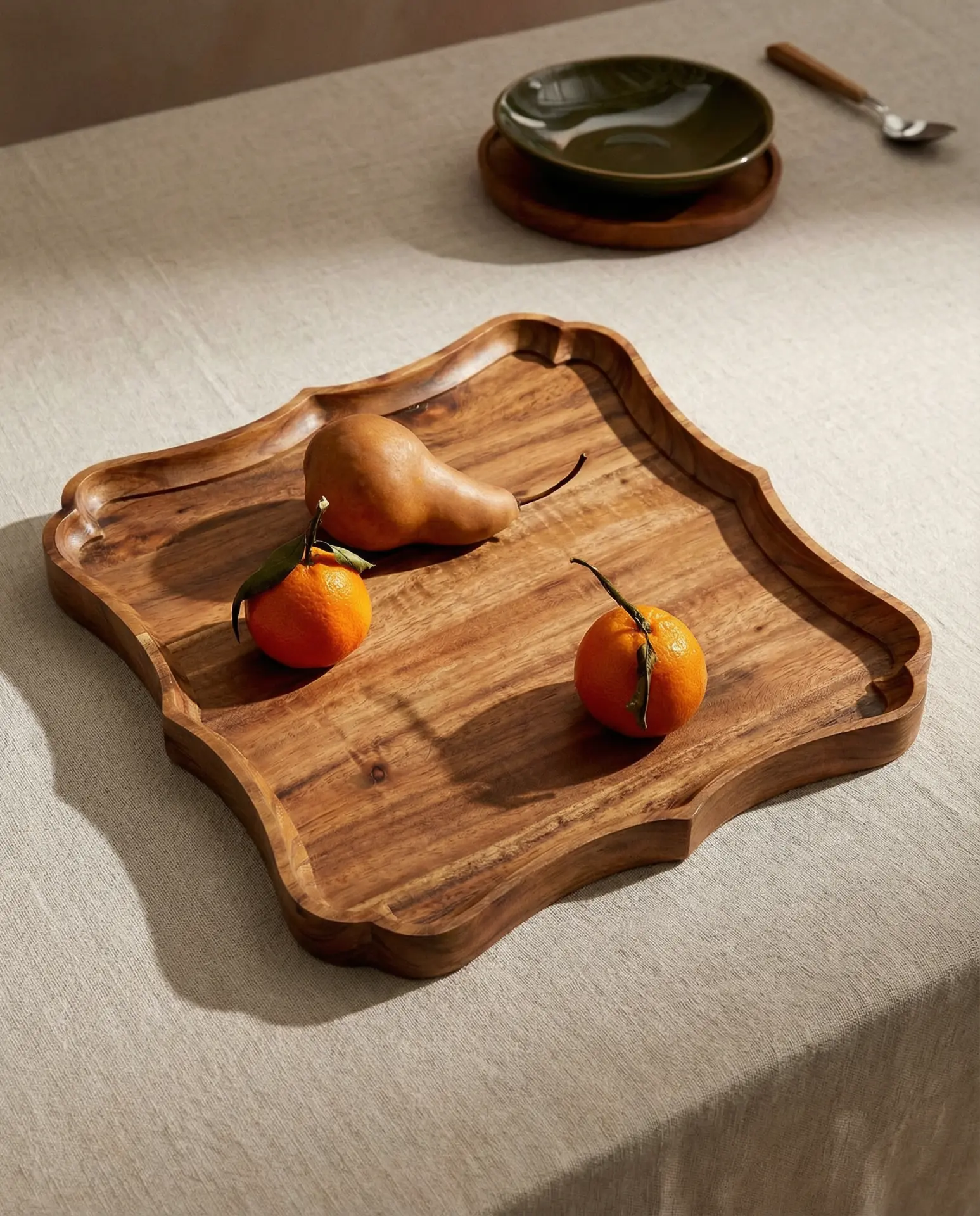 Scalloped wooden serving tray with fruit