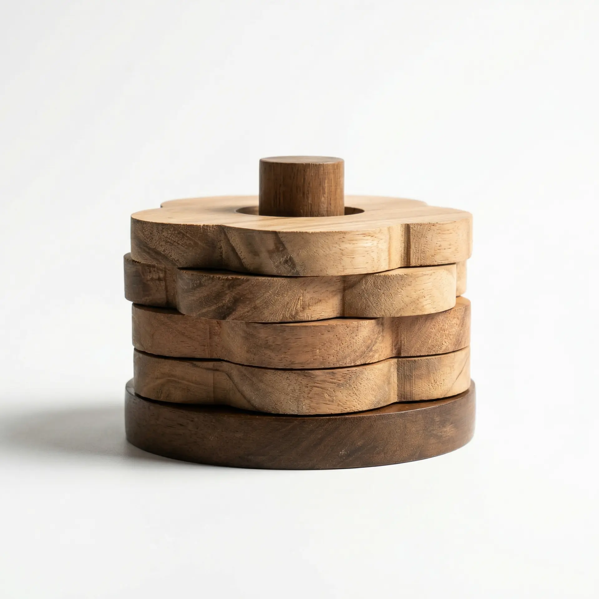 Stacked scalloped wooden coasters on a turned holder